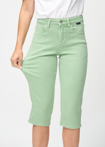 Das Model zieht die Capris am Oberschenkel, um den Stretch zu zeigen.