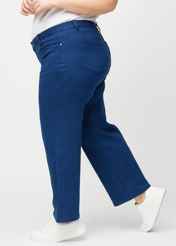Dunkelblaue loose jeans von der Seite an einem Plus-Size-Model gesehen.