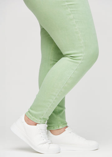 Skinny-Jeans für Damen in Hellgrün, Farbe Mints. Nahaufnahme der eng anliegenden Beinabschlüsse am Knöchel eines Plus-Size-Models.