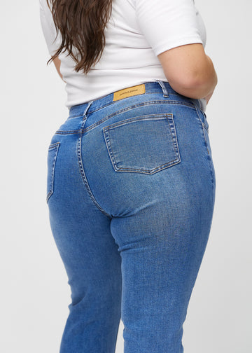 Slim-Jeans für Damen in Blau, Farbe Rivers. Nahaufnahme der Rückseite an einem Plus-Size-Model, die Details sind gut erkennbar.