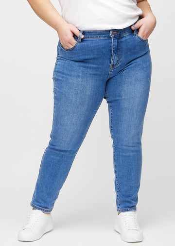 Slim-Jeans für Damen in Blau, Farbe Rivers. Vorderansicht an einem Plus-Size-Model, körpernah geschnitten mit etwas mehr Platz am Knöchel.