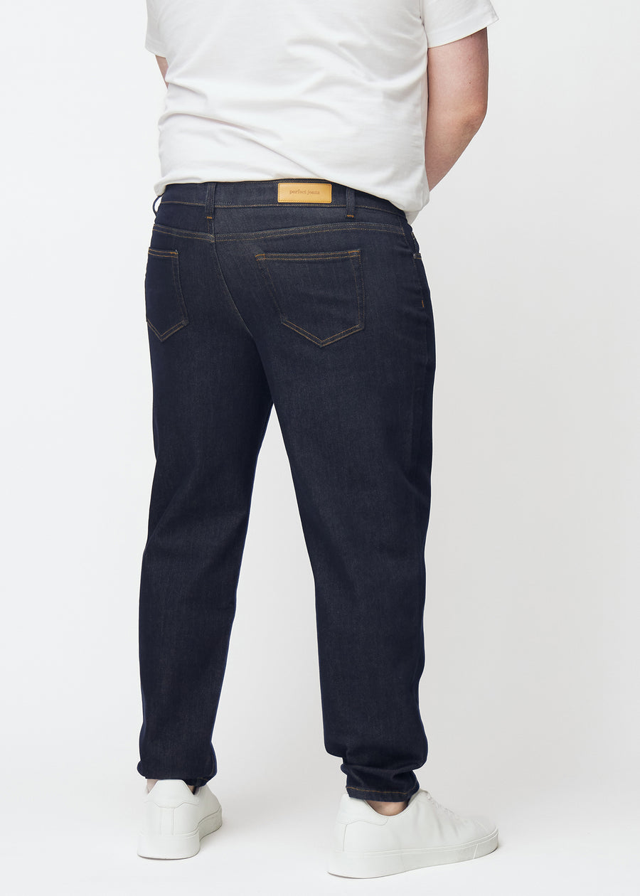 Tief dunkelblaue Denim jeans für Herren in der Farbe Midnights von hinten an einem Plus-Size-Model gesehen.