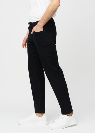 Schwarze regular jeans von der Seite an einem Model gesehen.