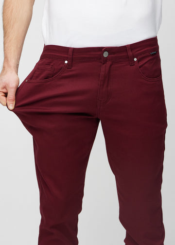 Ein Model dehnt die Jeans am Oberschenkel, um den Stretch des Materials zu zeigen.