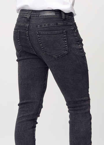 Nahaufnahme von hinten von dunkelgraue Denim-Jeans im Slim Fit, die Details zeigt.