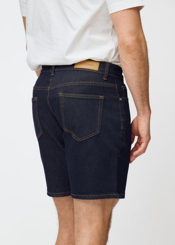 dunkelblaue denim shorts für herren in der farbe midnights von hinten nah aufgenommen, um passform und details zu zeigen.
